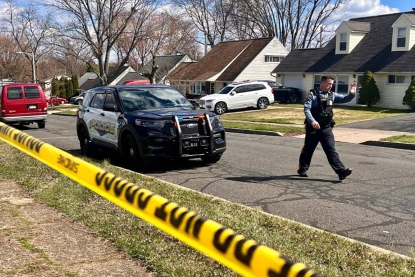 A police officer patrols a neighborhood in Levittown, Pennsylvania, just north of Philadel