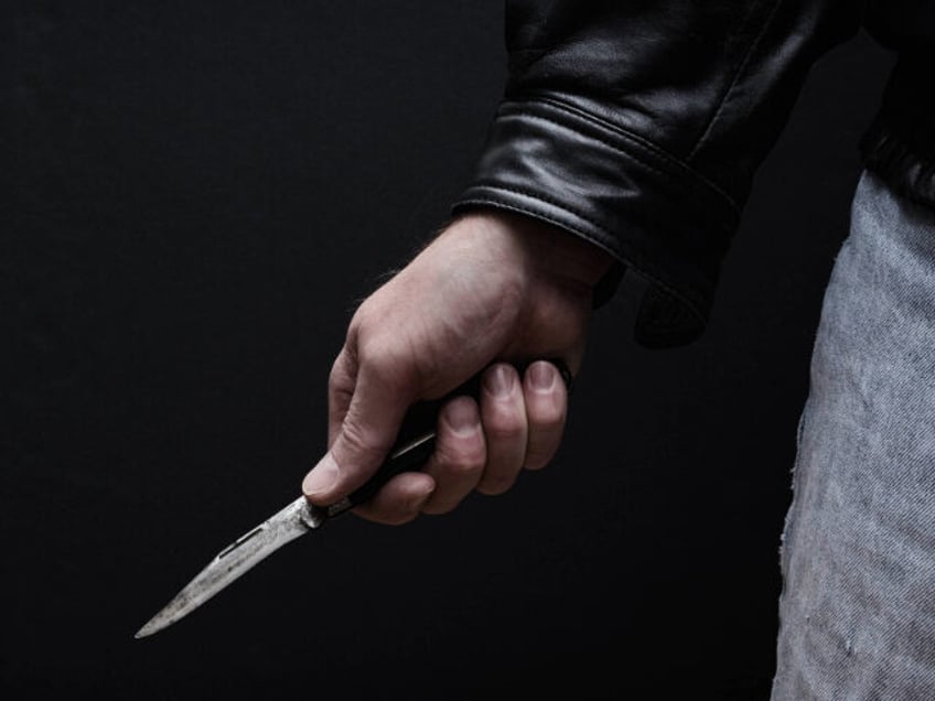 Man Brandishing Knife - stock photo