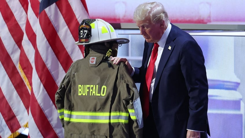 Donald Trump with fireman's coat at DNC tribute