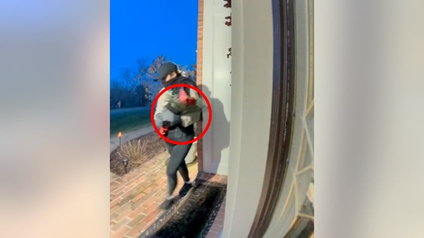 Woman holding roses at a front door in Farifax County