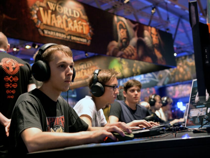 COLOGNE, GERMANY - AUGUST 14: Visitors try out the massively multiplayer online role-playing game 'World Of Warcraft' at the Blizzard Entertainment stand at the 2014 Gamescom gaming trade fair on August 14, 2014 in Cologne, Germany. Gamescom is the world's largest gaming convention and this year includes over 600 exhibitors. …