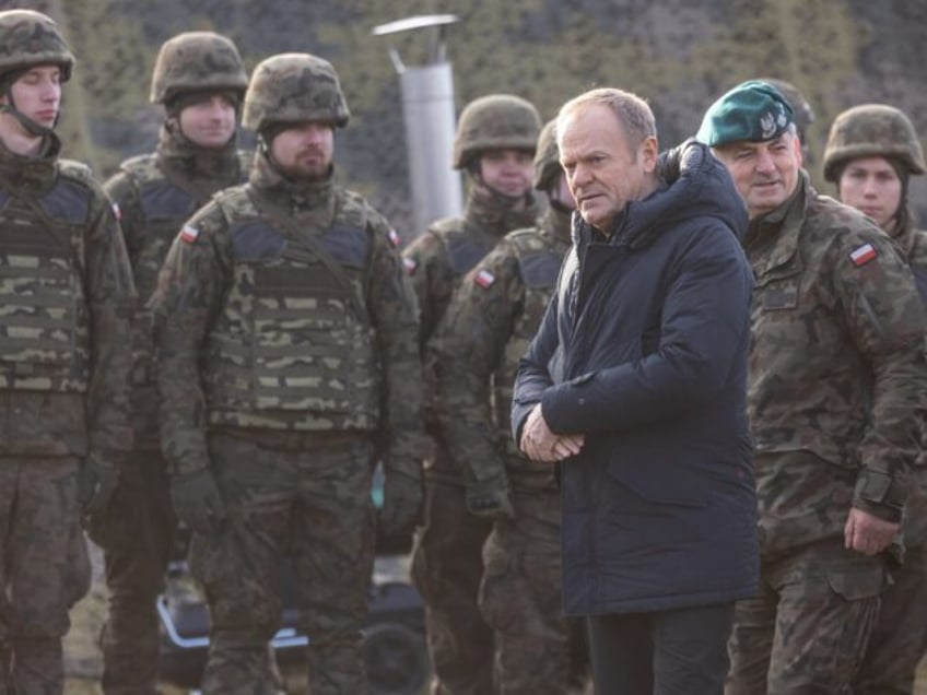 Poland's Prime Minister Donald Tusk (2R) and general Marek Wawrzyniak - Chief of the Milit