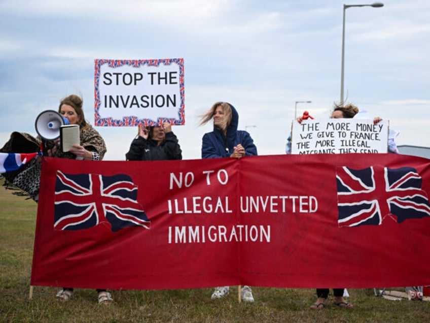 PORTLAND, ENGLAND - SEPTEMBER 16: Protesters against illegal immigration and the Bibby Stockholm barge demonstrate, on September 16, 2023 in Portland, England. The floating accommodation has been hired by the UK Home Office to house between 400 and 500 asylum seekers, although its first residents were evacuated days after their …