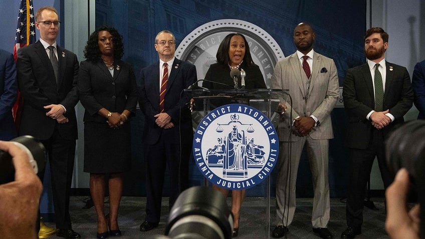 DA Fanis Willis with others at news conference