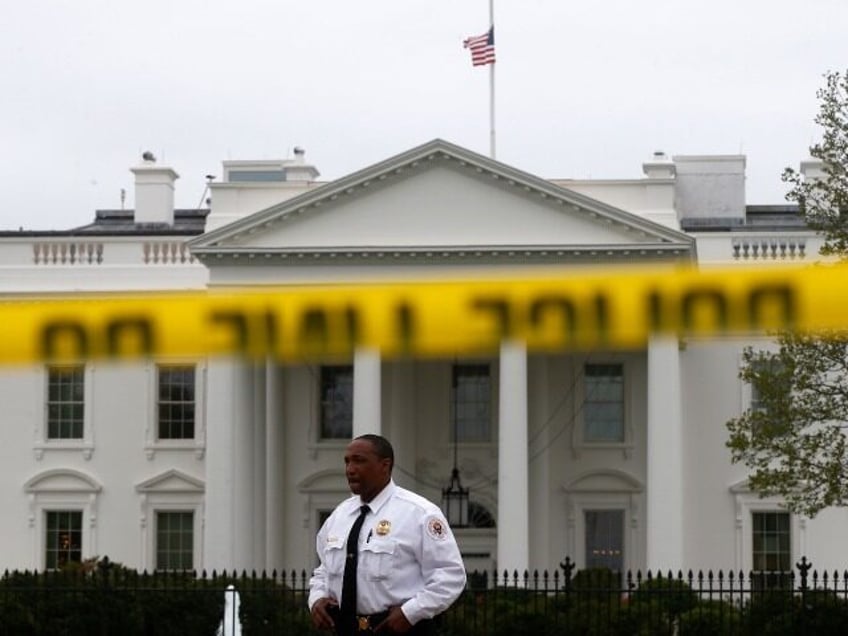 A Uniformed Division Secret Service officer stands guard behind police tape on Pennsylvani