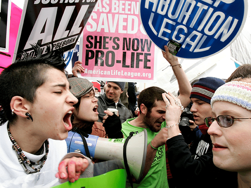 Pro-choice activists (L) argue with Pro-life activists (R) on abortion issues in front of