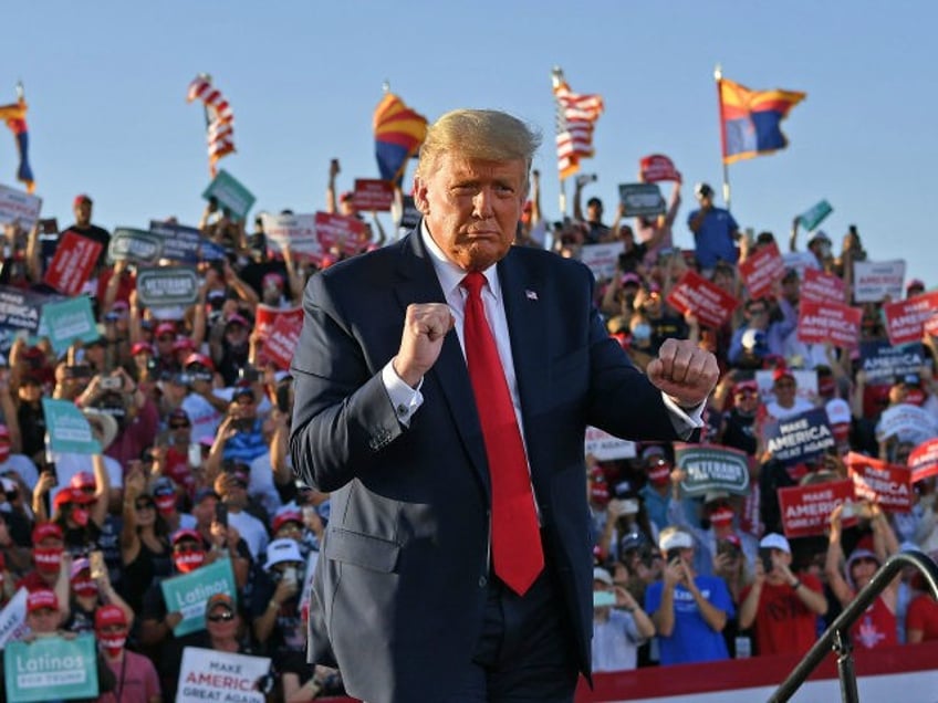 US President Donald Trump dances as he leaves a rally at Tucson International Airport in T