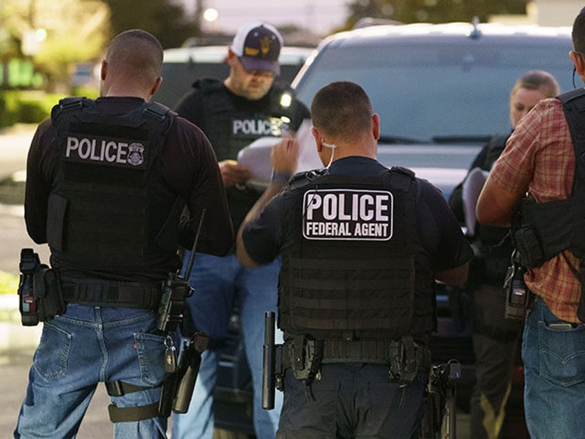 U.S. Immigration and Customs Enforcement agents gather before a raid to arrest immigrants