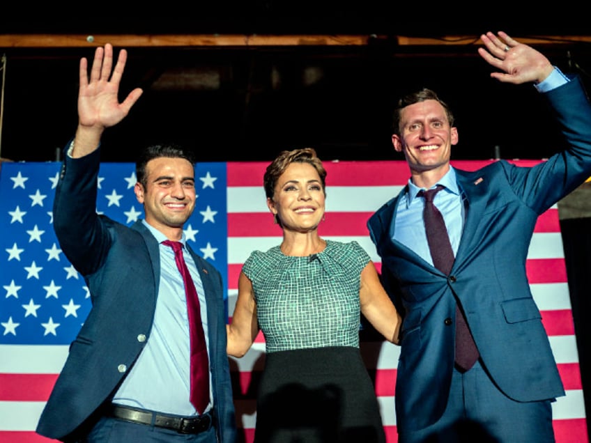 PHOENIX, ARIZONA - AUGUST 01: (L-R) Republican candidate for state attorney general Abraham Hamadeh, Republican gubernatorial candidate Kari Lake, and Republican U.S. senatorial candidate Blake Masters wave to supporters at the conclusion of a campaign event on the eve of the primary at the Duce bar on August 01, 2022 in Phoenix, Arizona. Lake, who has the endorsement of former President Donald Trump, is facing Karrin Taylor Robson, who is being backed by former Vice President Mike Pence. (Photo by Brandon Bell/Getty Images)