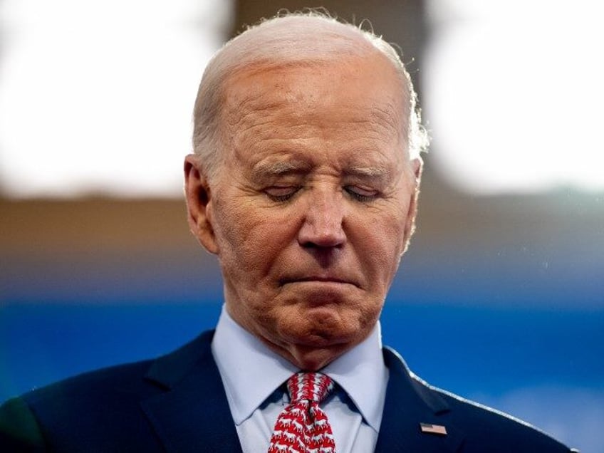 U.S. President Joe Biden stands on stage as U.S. Vice President Kamala Harris introduces h