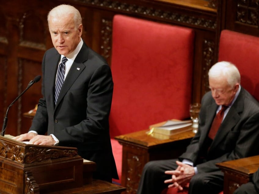 Vice President Joe Biden pays tribute to Joan Mondale at her memorial service at Westminster Presbyterian Church as former President Jimmy Carter, right, waits to speak, Saturday, Feb. 8, 2014 in Minneapolis. Joan Mondale, 83, died Feb. 3. (AP Photo/Jim Mone)