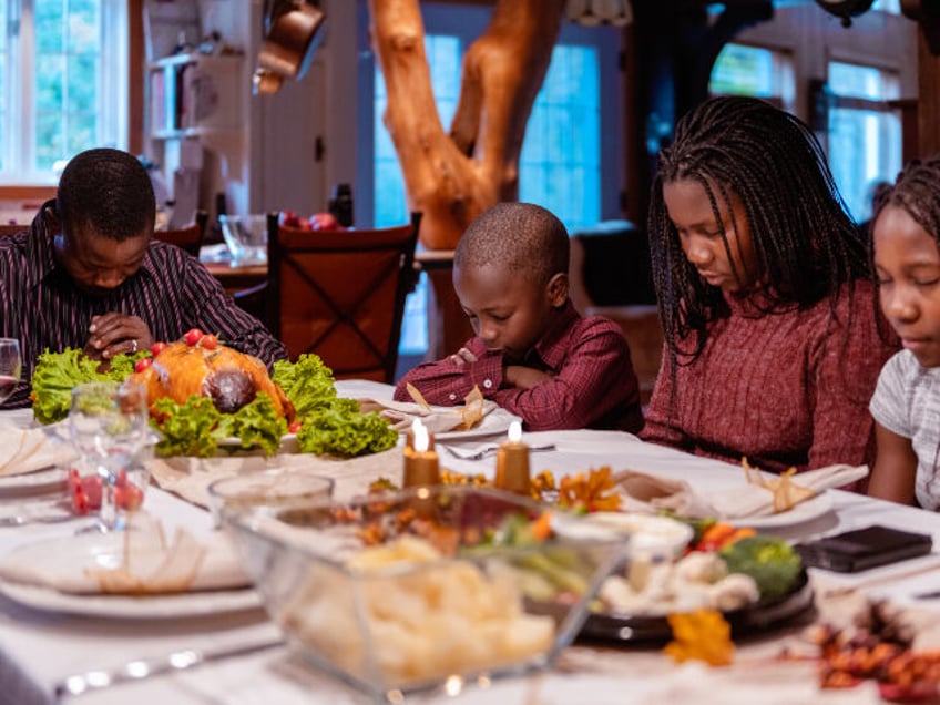 Thanksgiving_ Family prays at Thanksgiving dinner