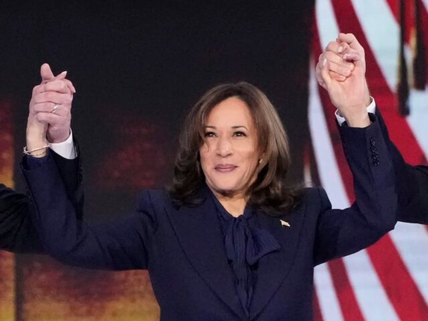 Democratic presidential nominee Vice President Kamala Harris holds the hands of second gen