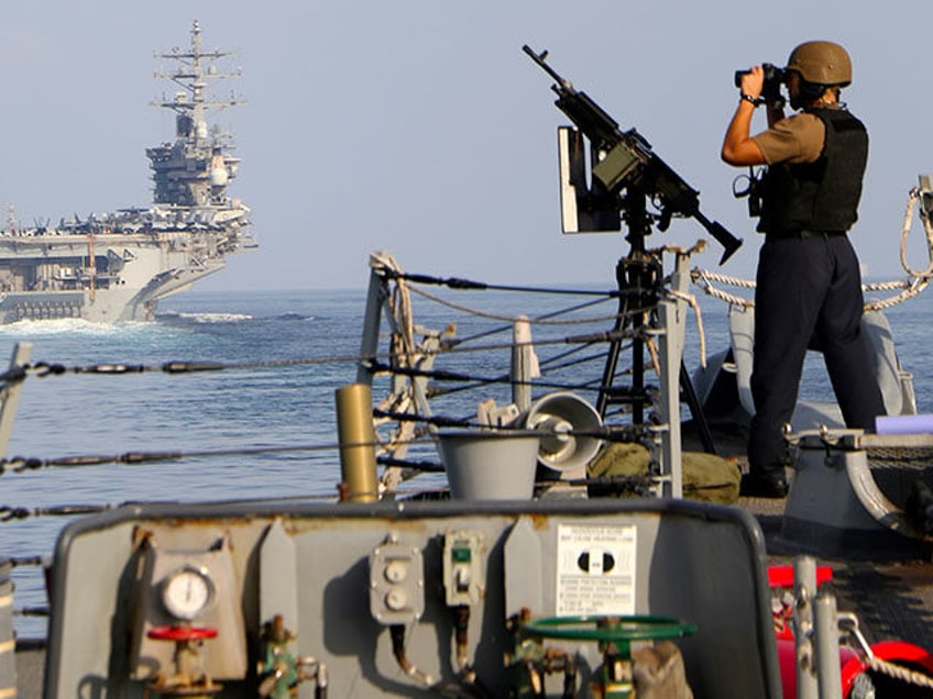 The aircraft carrier USS Dwight D. Eisenhower and other warships crosses the Strait of Hormuz into the Persian Gulf on Sunday, Nov. 26, 2023, as part of a wider American deployment in the Middle East amid the Israel-Hamas war. The Eisenhower was accompanied by the guided-missile cruiser USS Philippine Sea, …