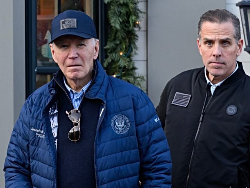 A November 29, 2024 photo shows US President Joe Biden and son Hunter Biden stepping out o