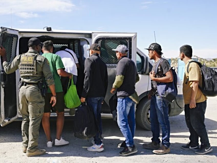 ACUMBA HOT SPRINGS, CALIFORNIA - JUNE 9: Migrants are processed by the US Border Patrol ag