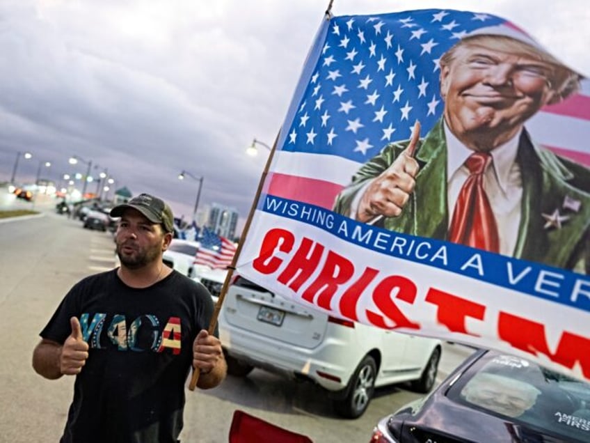 Justin Nevarez, a supporter of US President-elect Donald Trump makes the thumbs up sign as