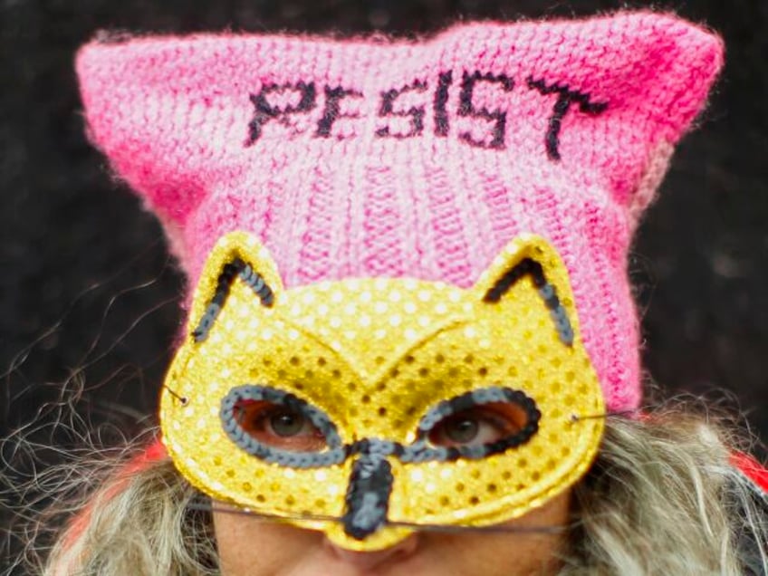 A woman takes part in a rally before the Women's March, on Saturday, Jan. 18, 2020 in