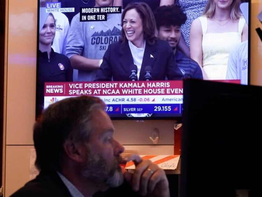 A television on the floor of the New York Stock Exchange shows U.S. Vice President Kamala