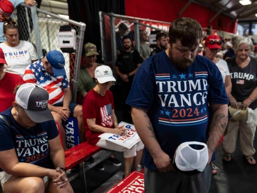 Supporters of Republican vice presidential candidate Sen. JD Vance, R-Ohio, pray during a