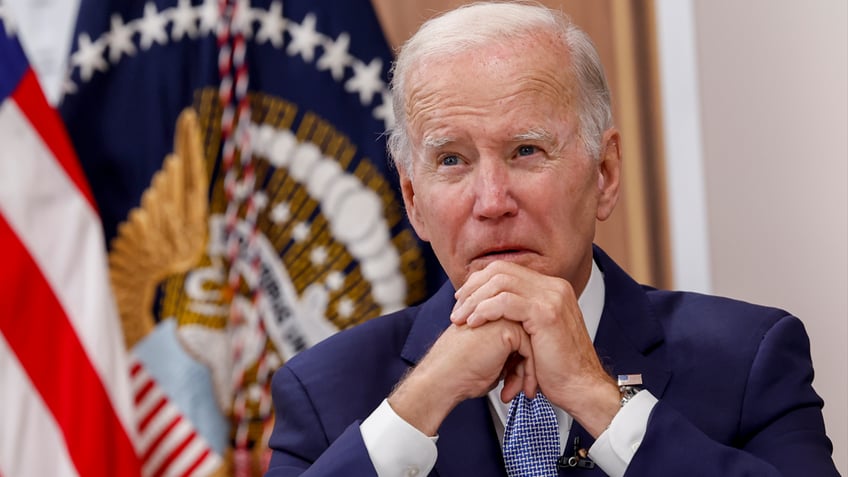 Biden sitting at a desk