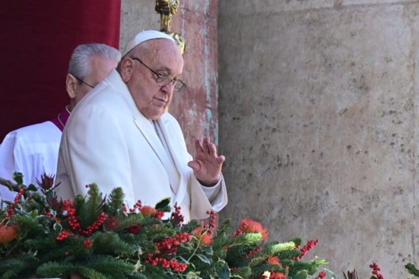 Pope Francis waves from the main balcony of St. Peter's basilica