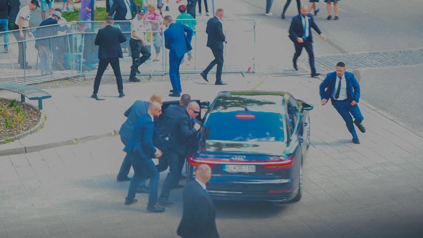 Slovak PM rushed to car