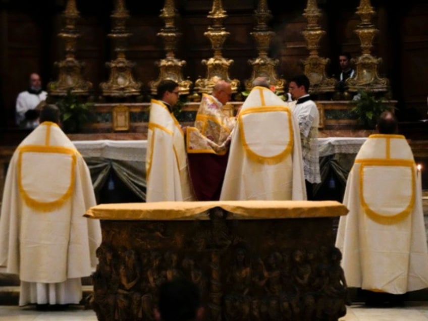 A celebrating priest leads a Latin Mass at Rome's ancient Pantheon basilica, in Rome, Italy, Friday, Oct. 29, 2021. Traditionalist Catholics descended on Rome on Friday for their annual pilgrimage, hoping to show the vibrancy of their community after Pope Francis issued a crackdown on the spread of the Latin Mass that many took as an attack on the ancient rite. An evening vespers service at Rome's ancient Pantheon basilica, the first event of the three-day pilgrimage, was so full that ushers had to add two rows of chairs to accommodate the faithful. Many young families, couples and priests filled the pews, hailing from the U.S., France, Spain and beyond. (AP Photo/Luca Bruno)