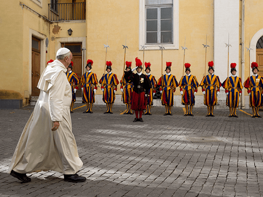 Pope Francis leaves past Swiss guards at the end of a private audience with Senegal's President Macky Sall at the Vatican, on November 18, 2014. AFP PHOTO POOL / ANDREW MEDICHINI (Photo by ANDREW MEDICHINI / POOL / AFP) (Photo by ANDREW MEDICHINI/POOL/AFP via Getty Images)