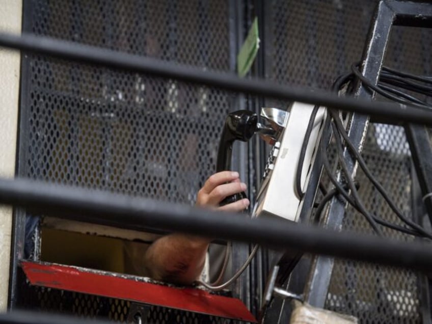 An inmate uses a telephone from a cell at San Quentin State Prison in San Quentin, Califor