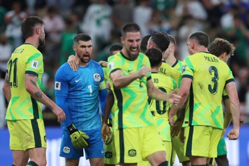 Australia's players celebrate after making the World Cup