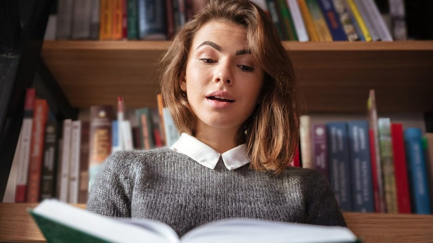 A woman reading at the library 