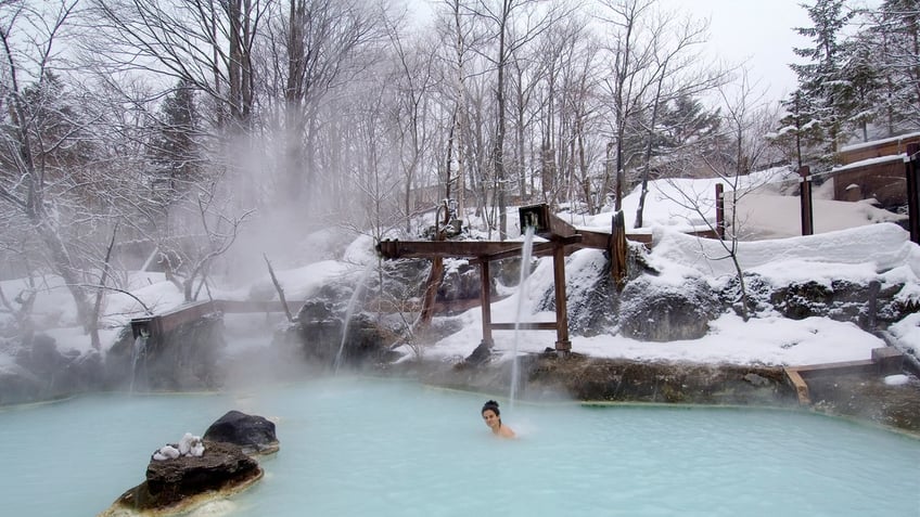 Visitors dip into hot springs in Japan