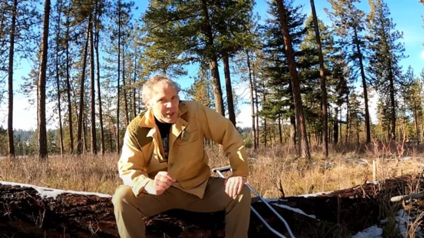 paul harrell sitting on a log in final video