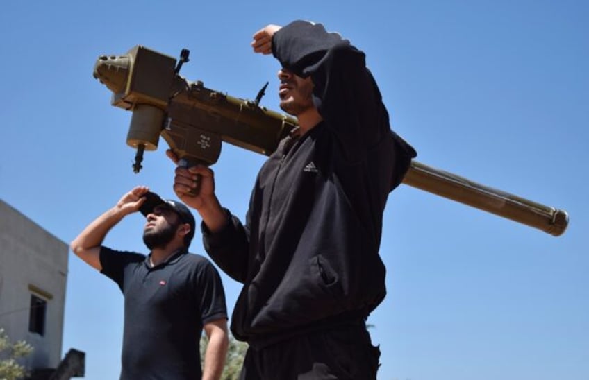 Rebel fighters monitor the sky holding a FN-6 man-portable air-defence system (MANPADS) in