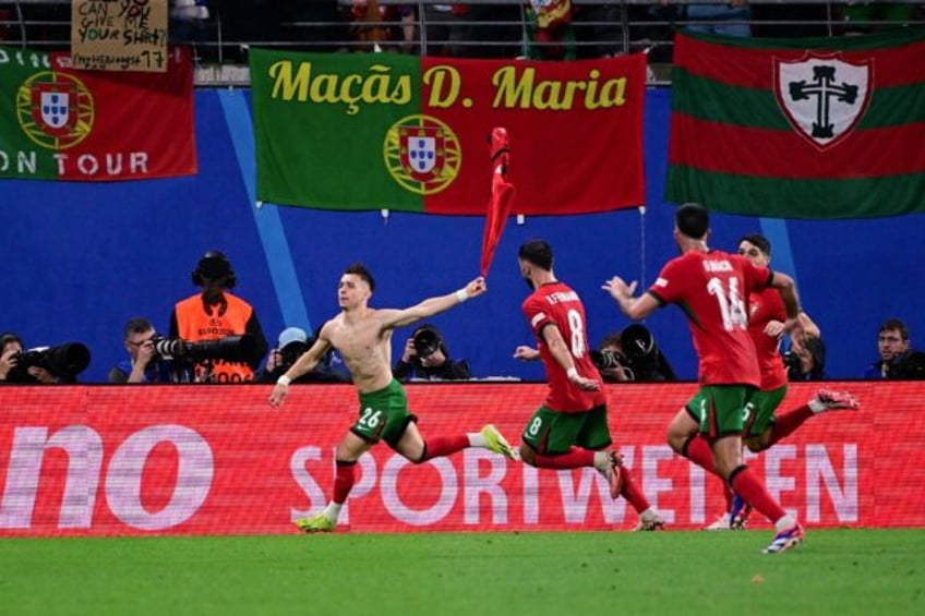 Francisco Conceicao (L) wheels away after scoring his country's winner in their opening Eu