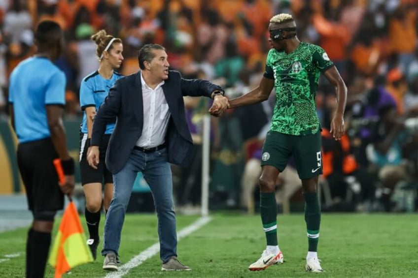 Nigeria's Portuguese coach Jose Peseiro (C) talks to star forward Victor Osimhen (R) durin