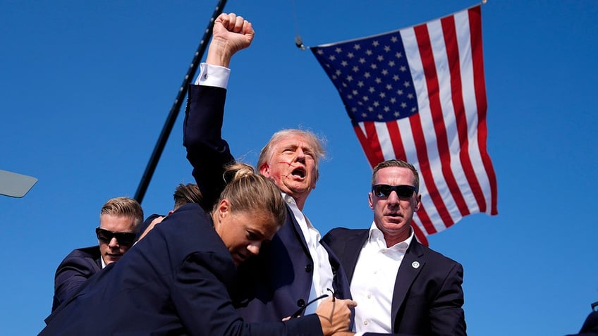 Republican presidential candidate former President Donald Trump is surrounded by U.S. Secret Service agents at a campaign rally, Saturday, July 13, 2024, in Butler, Pa.