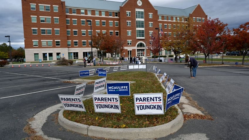 Students, parents and others hold signs outside the Loudoun County school board meeting October 26, 2021, in Ashburn, VA. (Photo by Katherine Frey/The Washington Post via Getty Images)