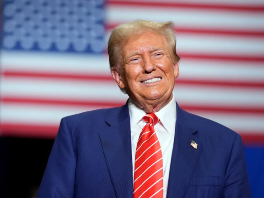 Republican presidential nominee former President Donald Trump smiles as he speaks at a cam