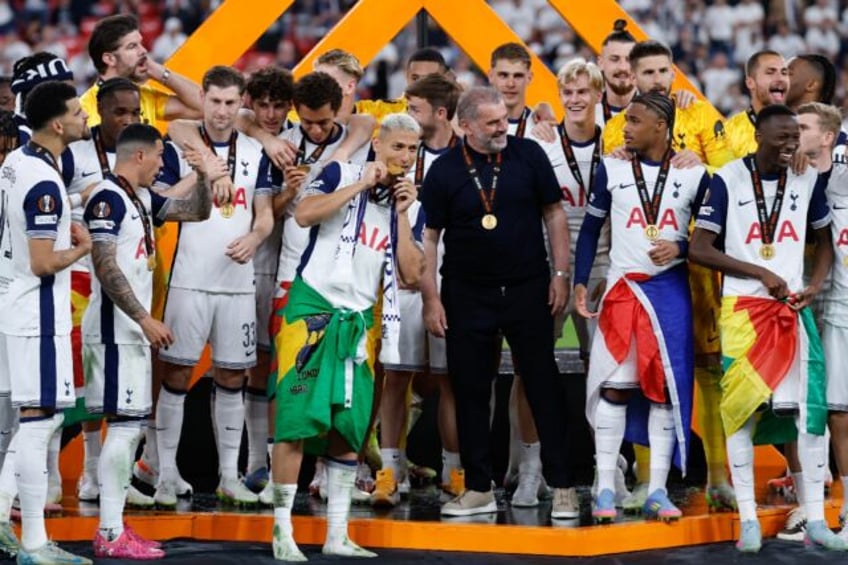 Tottenham Hotspur's coach Ange Postecoglou celebrates with his players after they won the
