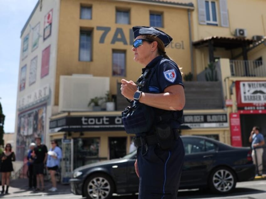 A municipal police officer directs traffic as traffic lights no longer function after a po