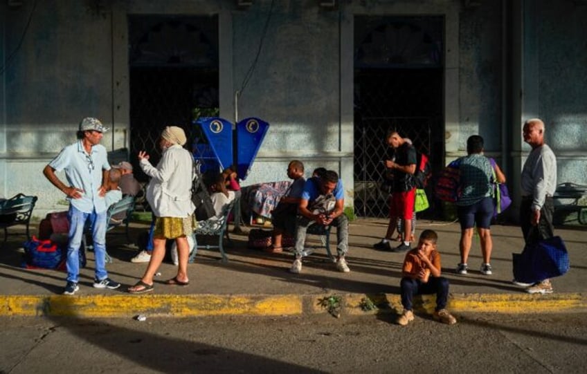 People wait for transportation at a bus station in Matanzas, Cuba, on October 18, 2024, du