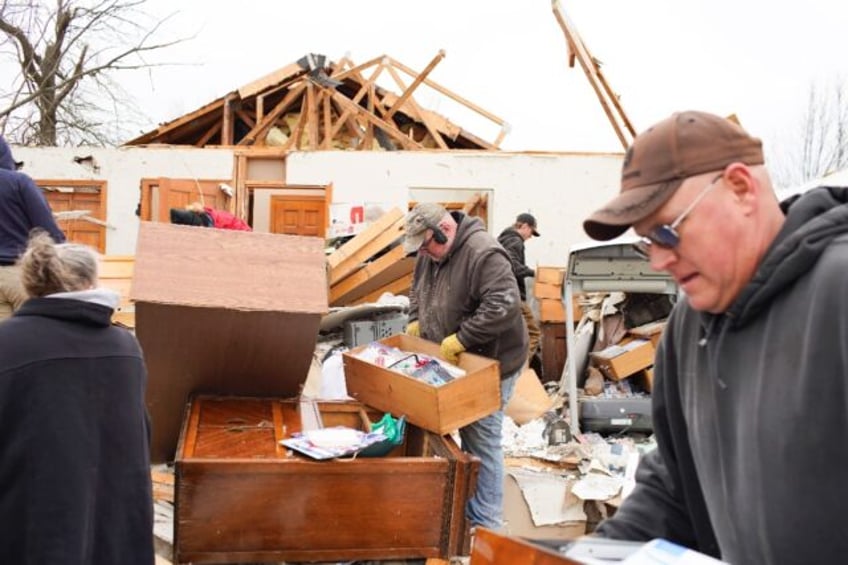 Residents sift through the debris as they clean up after a tornado struck Indian Lake, Ohi