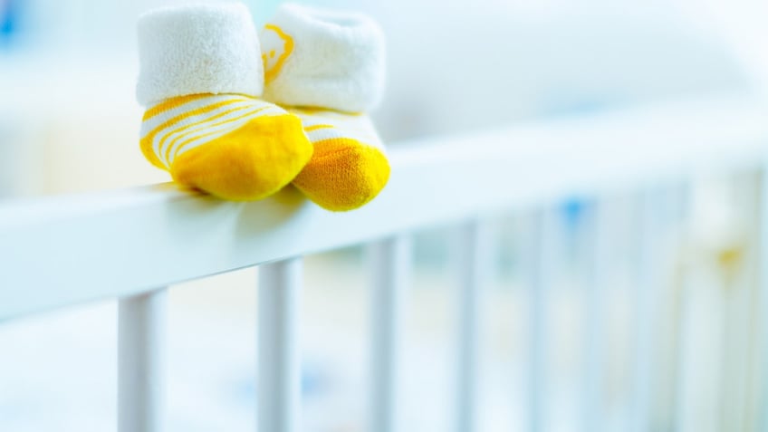 baby booties on a cot
