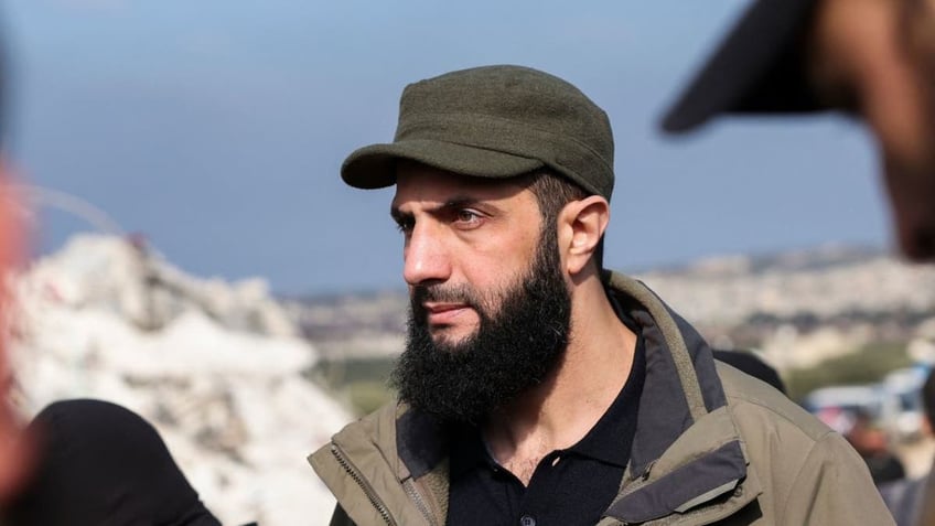 The Hayat Tahrir al-Sham jihadist group's chief, Abu Mohamed al-Jolani, checks the damage after an earthquake in the village of Besnaya in Syria's rebel-held northwestern Idlib province at the border with Turkey on Feb. 7, 2023. (OMAR HAJ KADOUR/AFP via Getty Images)