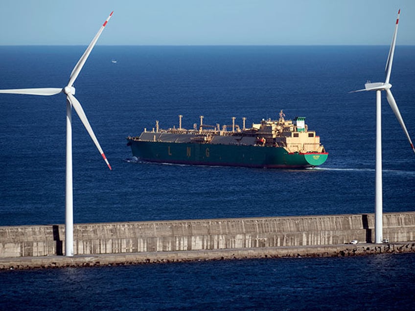 The LNG Ogun, a gas carrier that sails under the Bermuda flag, is pictured behind some wind turbines on a breakwater, leaving the Port of Bilbao bound for the port of Bonny, in Nigeria, after her stopover at the Bizkaia Bay regasification plant Gas (BBG) in Zierbena, 20 km away …