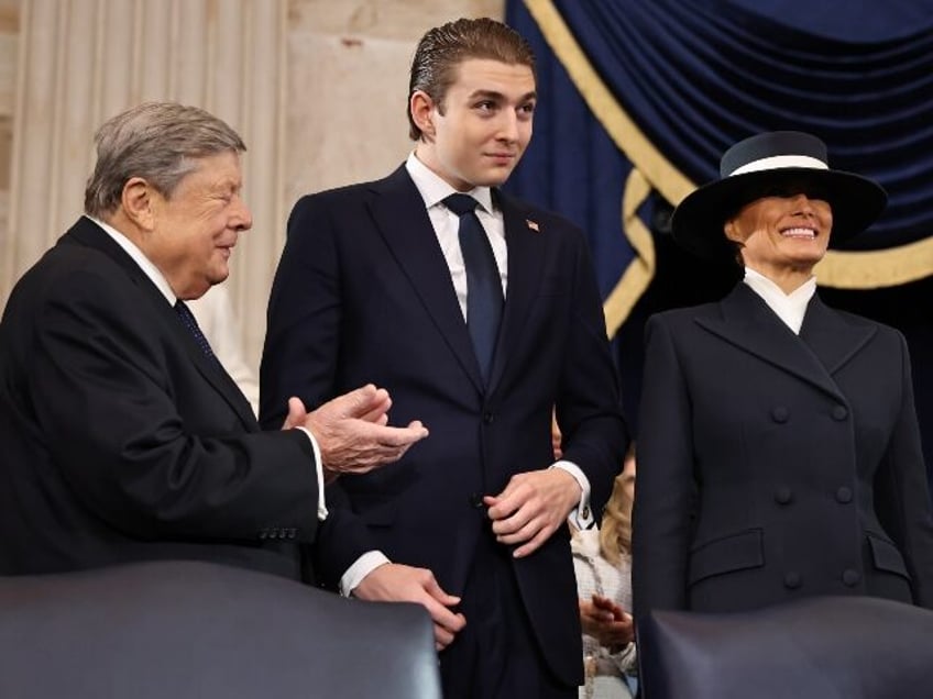 Barron Trump standing with his mother