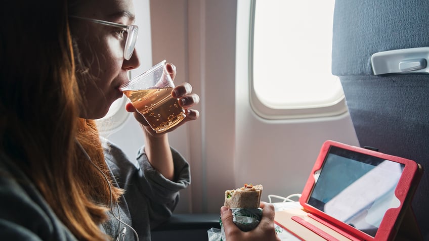 flight passenger drinking