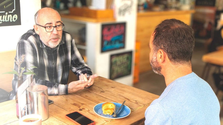 Men talking at coffee shop